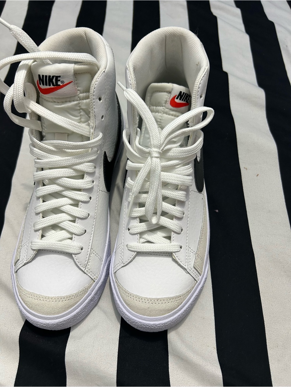 Nike White High-Top Sneakers with Black Swoosh and Red Logo